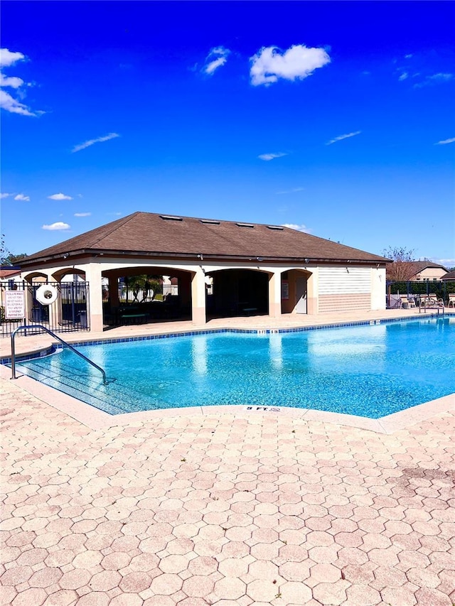 community pool featuring fence