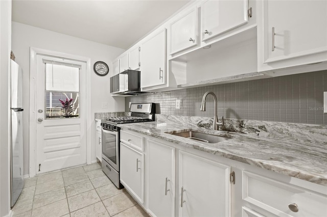 kitchen featuring light stone counters, sink, stainless steel appliances, and white cabinets