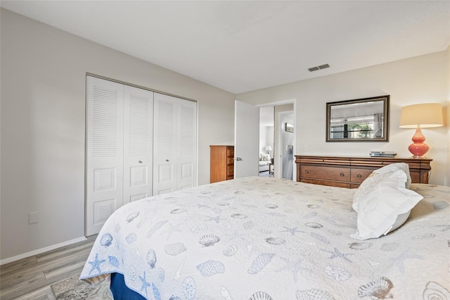 bedroom with wood-type flooring and a closet