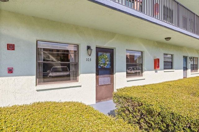 property entrance with a lawn