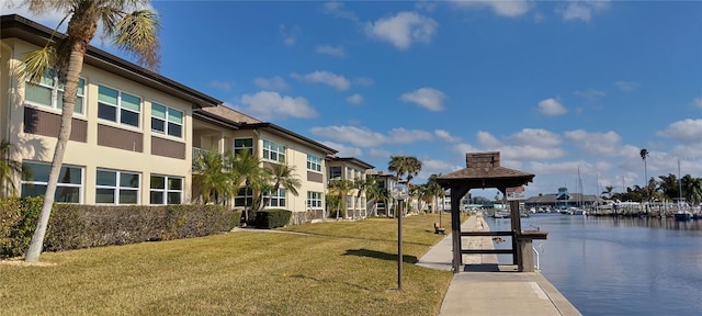 view of property's community featuring a gazebo, a lawn, and a water view