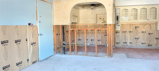 interior space with concrete floors and ceiling fan