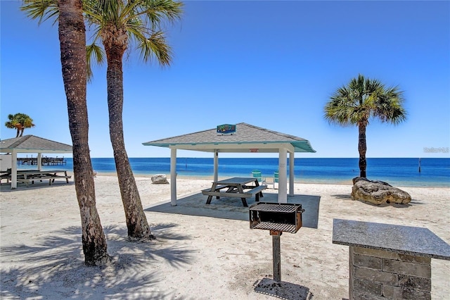 property view of water featuring a view of the beach and a gazebo