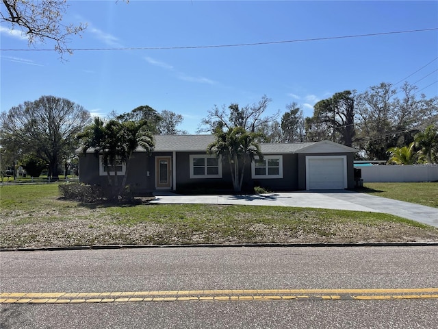 ranch-style house featuring stucco siding, an attached garage, a front yard, fence, and driveway