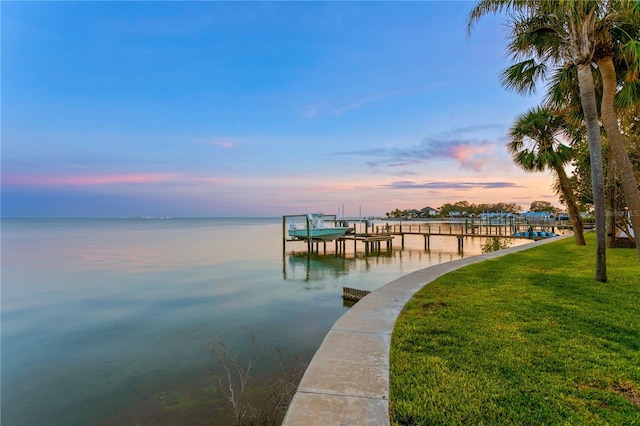 dock area featuring a water view and a lawn