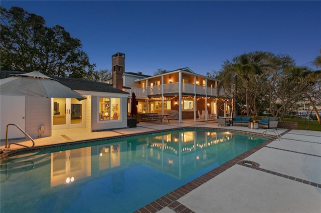 view of pool with an outdoor structure and a patio