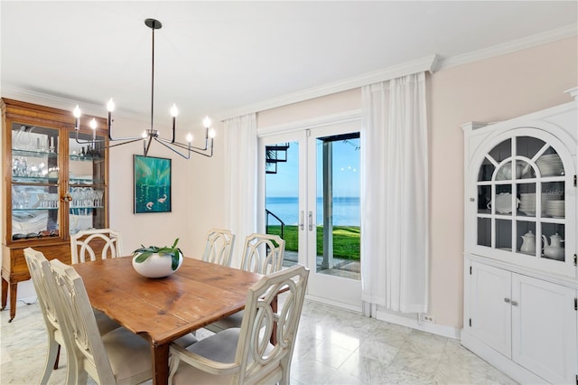 dining space with ornamental molding, french doors, and a water view