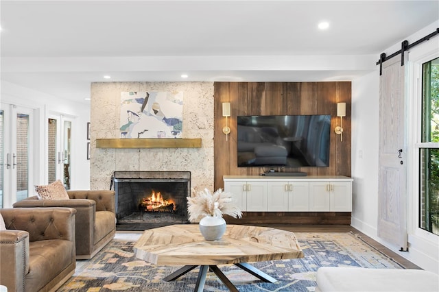 living room with a fireplace and a barn door