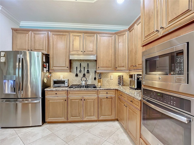 kitchen with backsplash, light tile patterned floors, stainless steel appliances, crown molding, and light stone countertops