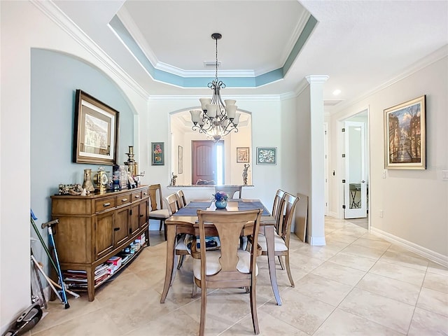 tiled dining room featuring an inviting chandelier, ornamental molding, and a raised ceiling