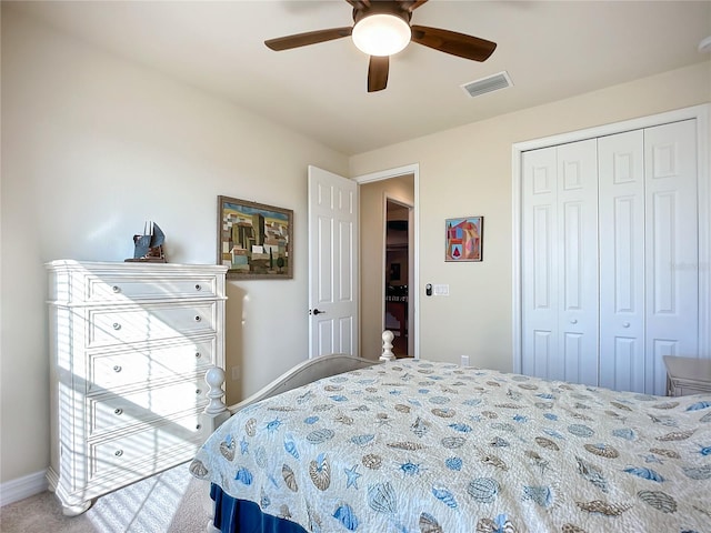 bedroom with ceiling fan, carpet, and a closet