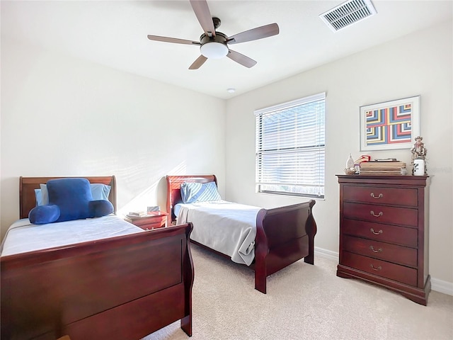 bedroom with ceiling fan and light carpet