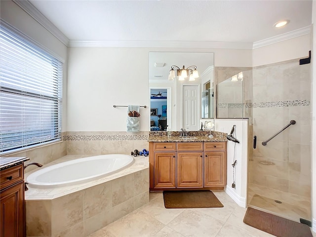 bathroom with plus walk in shower, ornamental molding, and vanity