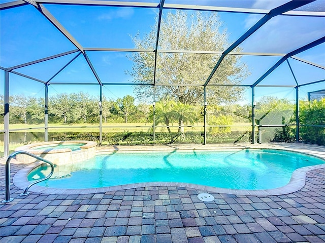 view of swimming pool with an in ground hot tub, a water view, glass enclosure, and a patio area