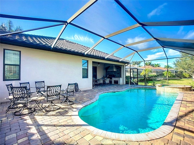 view of swimming pool with ceiling fan, a patio, glass enclosure, and an in ground hot tub