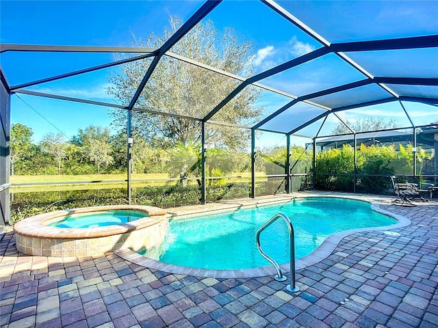 view of swimming pool with an in ground hot tub, a lanai, and a patio