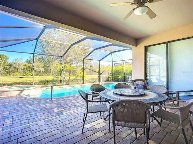 view of patio / terrace with a pool with hot tub, a lanai, and ceiling fan