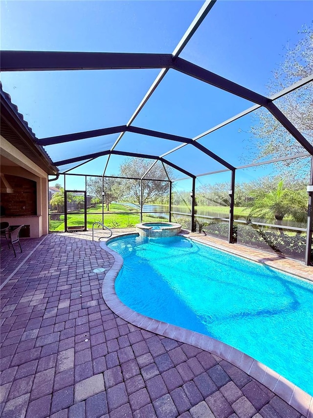 view of pool with an in ground hot tub, a lanai, and a patio area