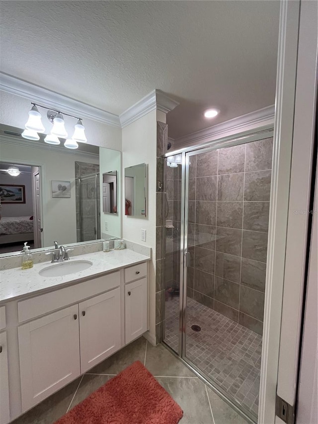 bathroom featuring crown molding, tile patterned flooring, vanity, a textured ceiling, and a shower with shower door