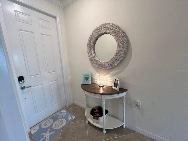 foyer entrance featuring dark tile patterned flooring and baseboards