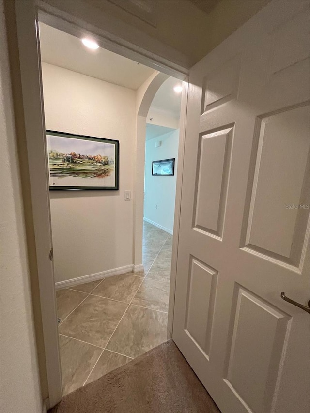 17520 Gawthrop Dr Unit 106, Lakewood Ranch, FL 34211 - corridor featuring arched walkways, light tile patterned flooring, and baseboards