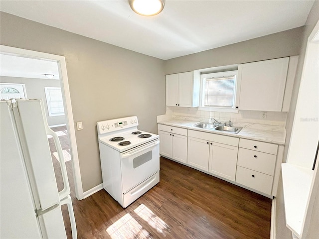 kitchen featuring white appliances, dark hardwood / wood-style floors, sink, and white cabinets