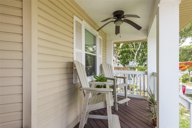 wooden deck with covered porch and ceiling fan