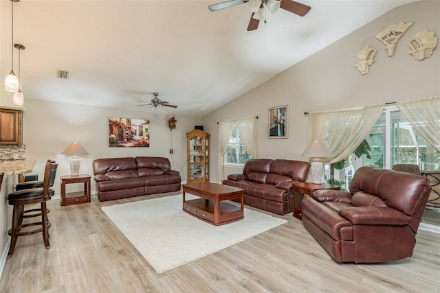 living room with vaulted ceiling, ceiling fan, and light hardwood / wood-style floors