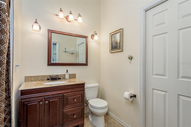 bathroom with vanity, tile patterned floors, and toilet