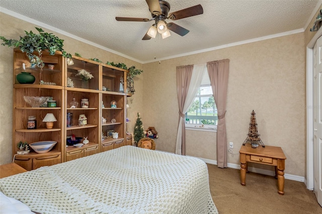 carpeted bedroom featuring ceiling fan, ornamental molding, and a textured ceiling