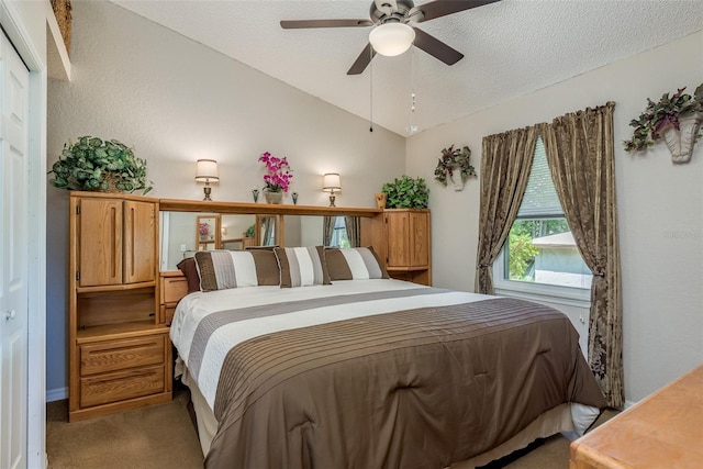 bedroom featuring lofted ceiling, ceiling fan, light colored carpet, and a textured ceiling