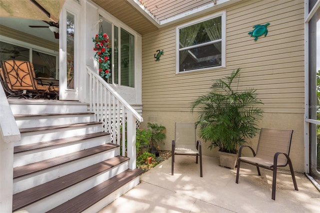 doorway to property with ceiling fan