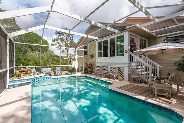 view of swimming pool featuring a lanai and a patio area