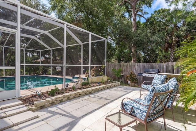 view of patio / terrace with a fenced in pool, area for grilling, and glass enclosure