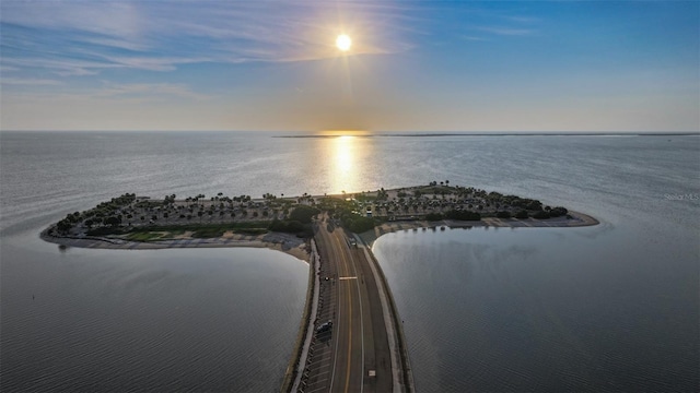 aerial view at dusk featuring a water view