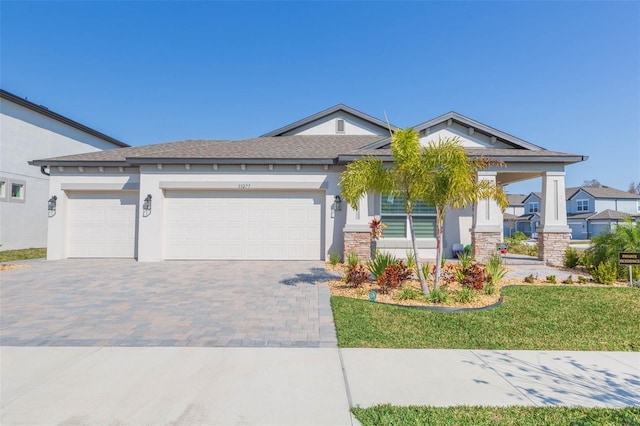 view of front of home featuring a garage and a front lawn