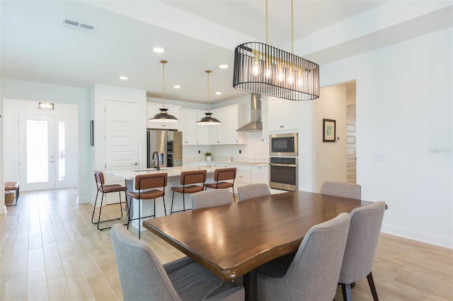 dining room with sink and light hardwood / wood-style floors