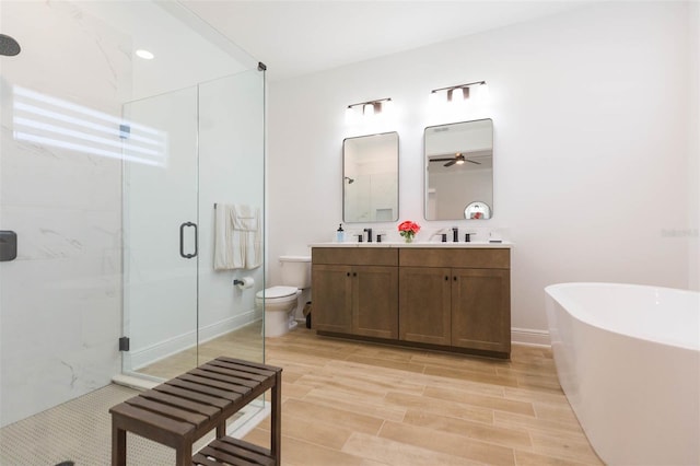 full bathroom featuring hardwood / wood-style flooring, vanity, separate shower and tub, and toilet