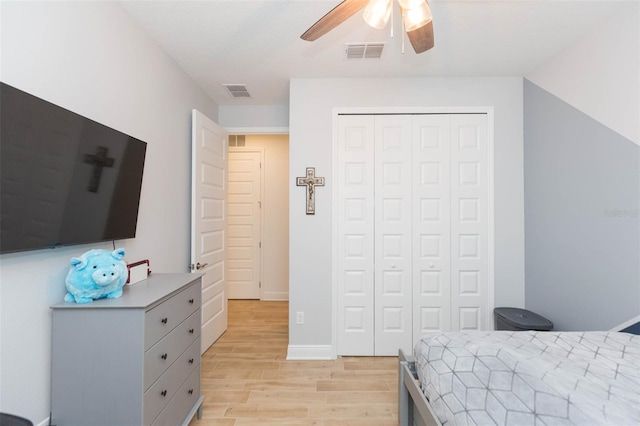 bedroom featuring light hardwood / wood-style flooring, a closet, and ceiling fan