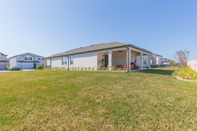 exterior space featuring a yard and ceiling fan