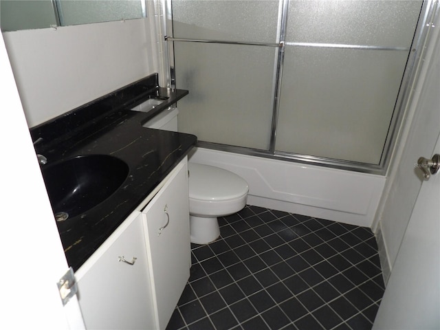 2623 Seville Blvd Unit 111, Clearwater, FL 33764 - full bath with vanity, toilet, shower / bath combination with glass door, and tile patterned flooring