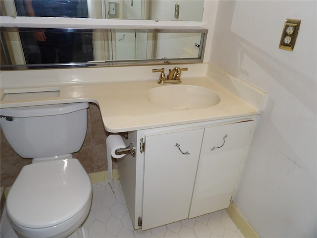2623 Seville Blvd Unit 111, Clearwater, FL 33764 - half bathroom with toilet, tile patterned flooring, and vanity