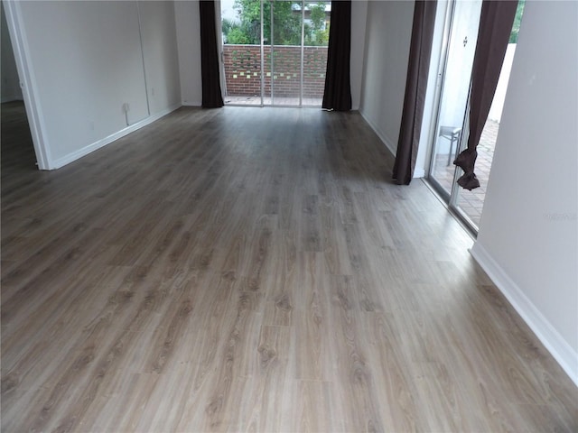 2623 Seville Blvd Unit 111, Clearwater, FL 33764 - empty room with baseboards and wood finished floors