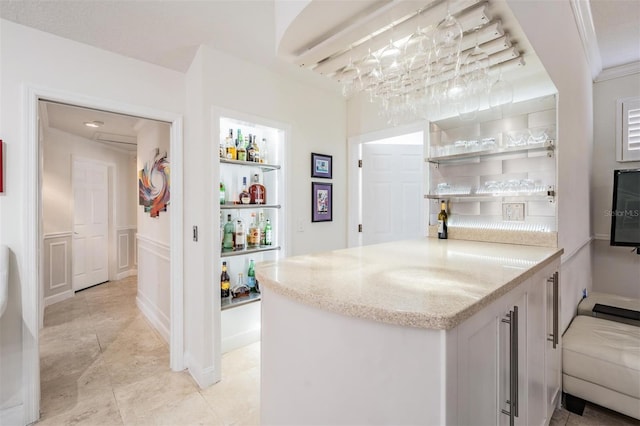 bar featuring light stone countertops