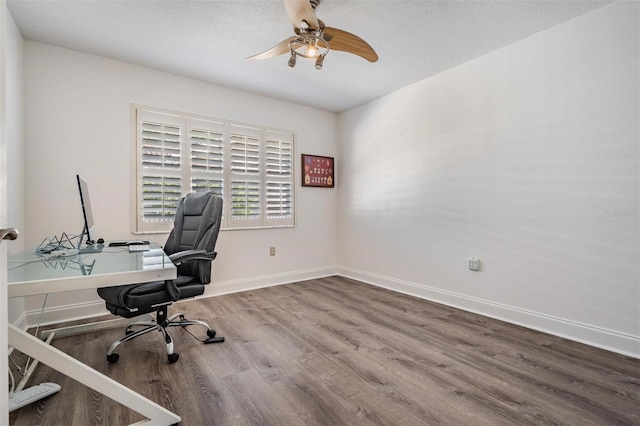 office space featuring hardwood / wood-style flooring, ceiling fan, and a textured ceiling