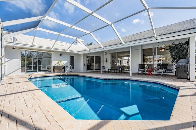 view of swimming pool with a patio and glass enclosure