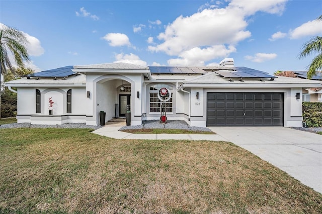 ranch-style home featuring a garage and a front yard