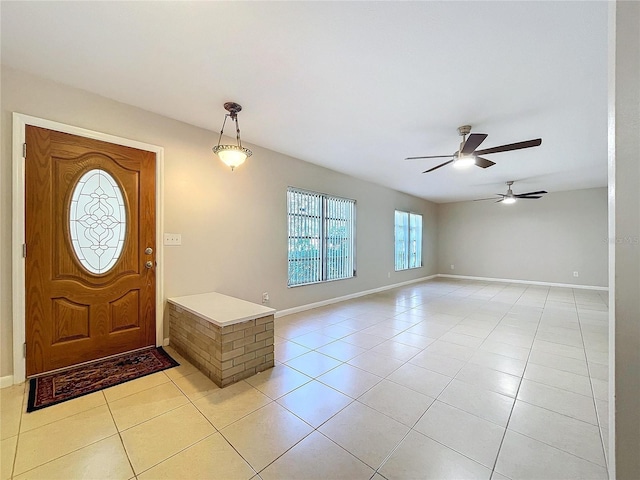 tiled entrance foyer featuring ceiling fan