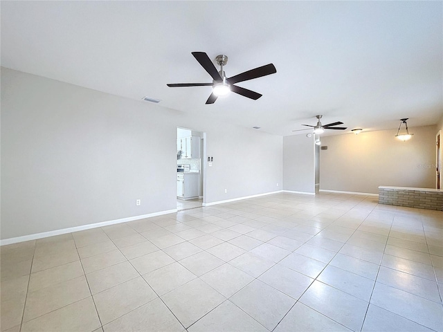 tiled empty room with ceiling fan