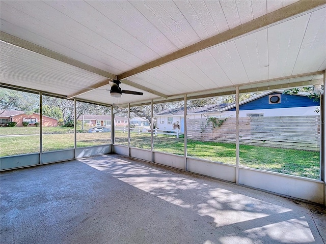 unfurnished sunroom with ceiling fan